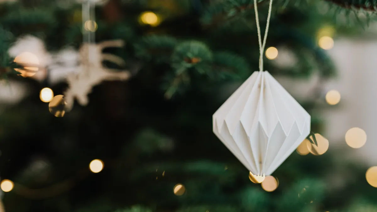 Folded paper ornament hanging on a tree