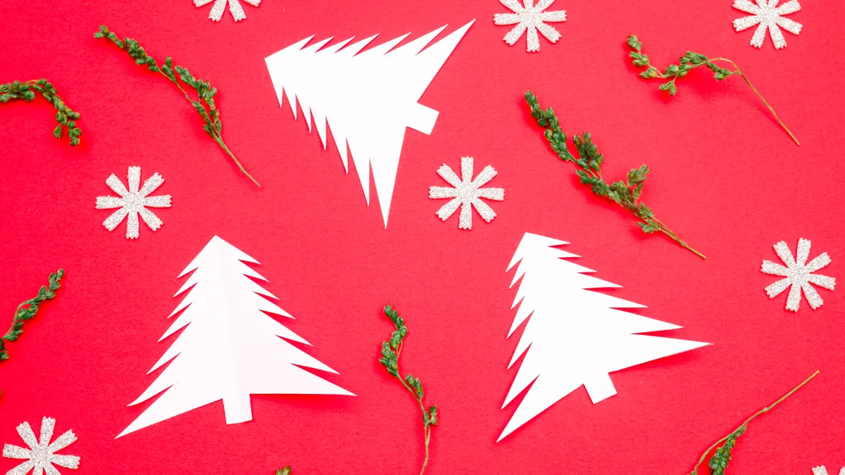 Paper Christmas tree cutouts and snowflakes