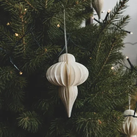 Paper ornament hanging on a Christmas tree