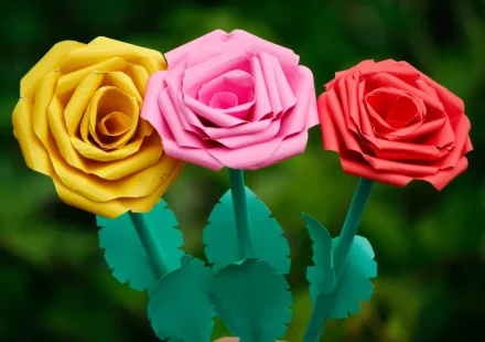 Hand holding colorful paper rose flowers