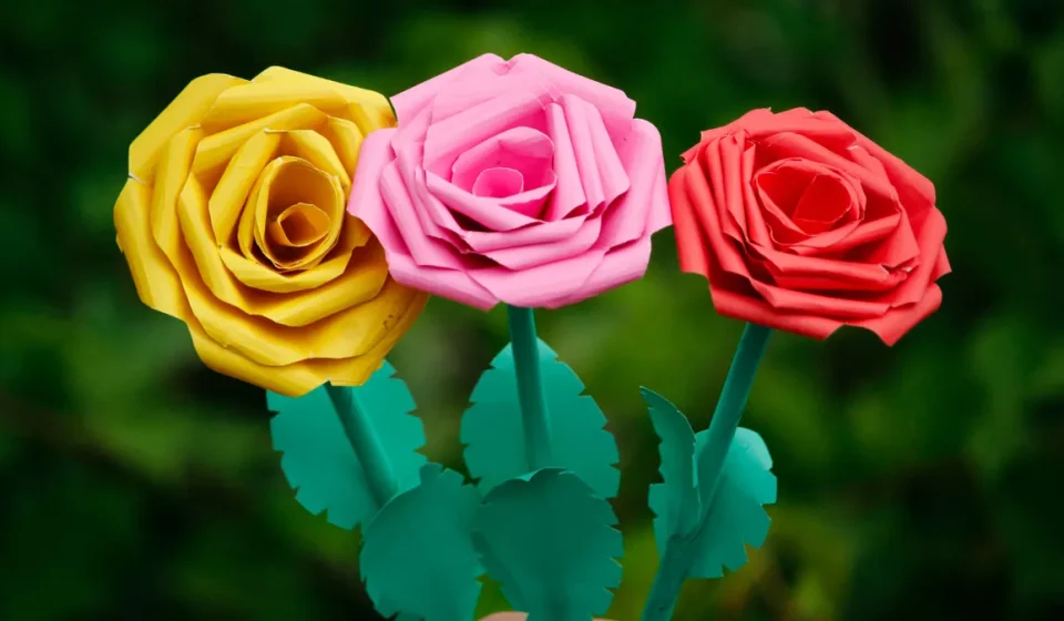 Hand holding colorful paper rose flowers