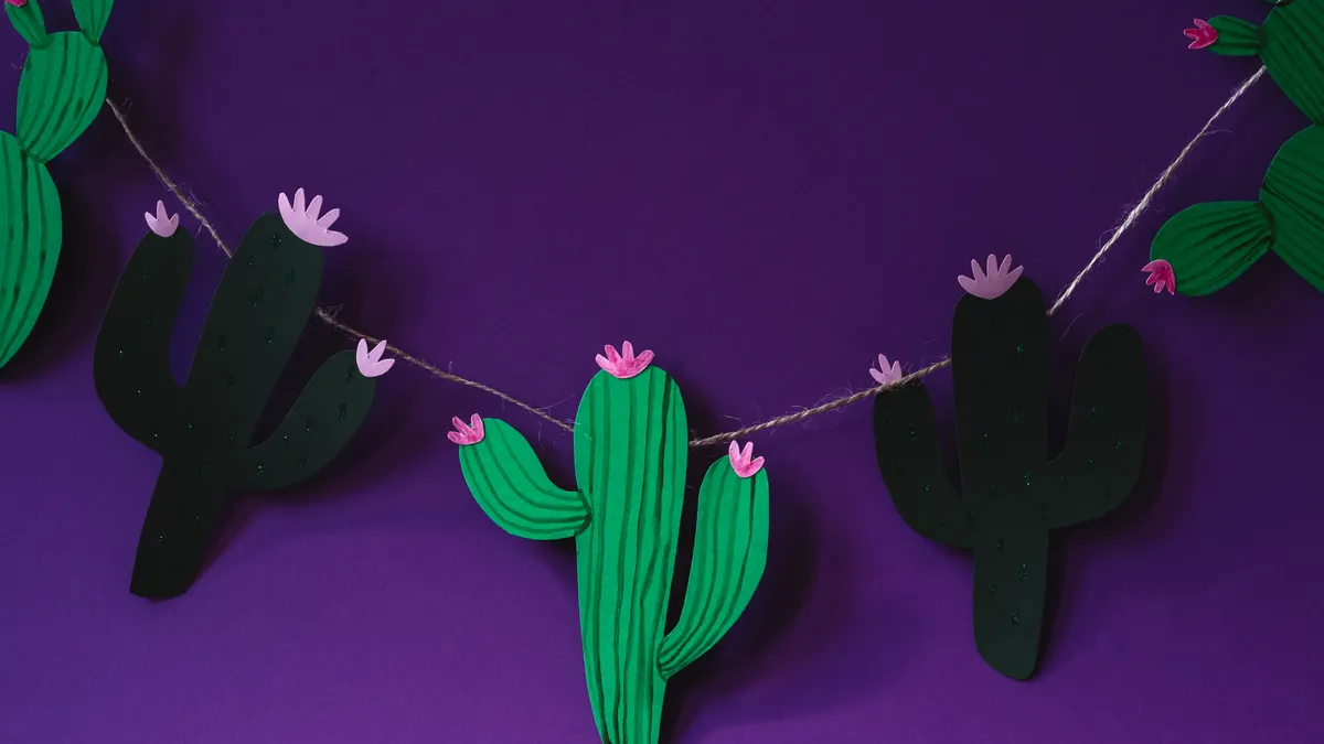 Paper cactus garland on a purple wall