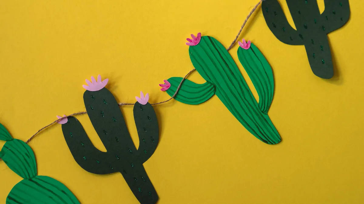 Paper cactus garland on yellow background